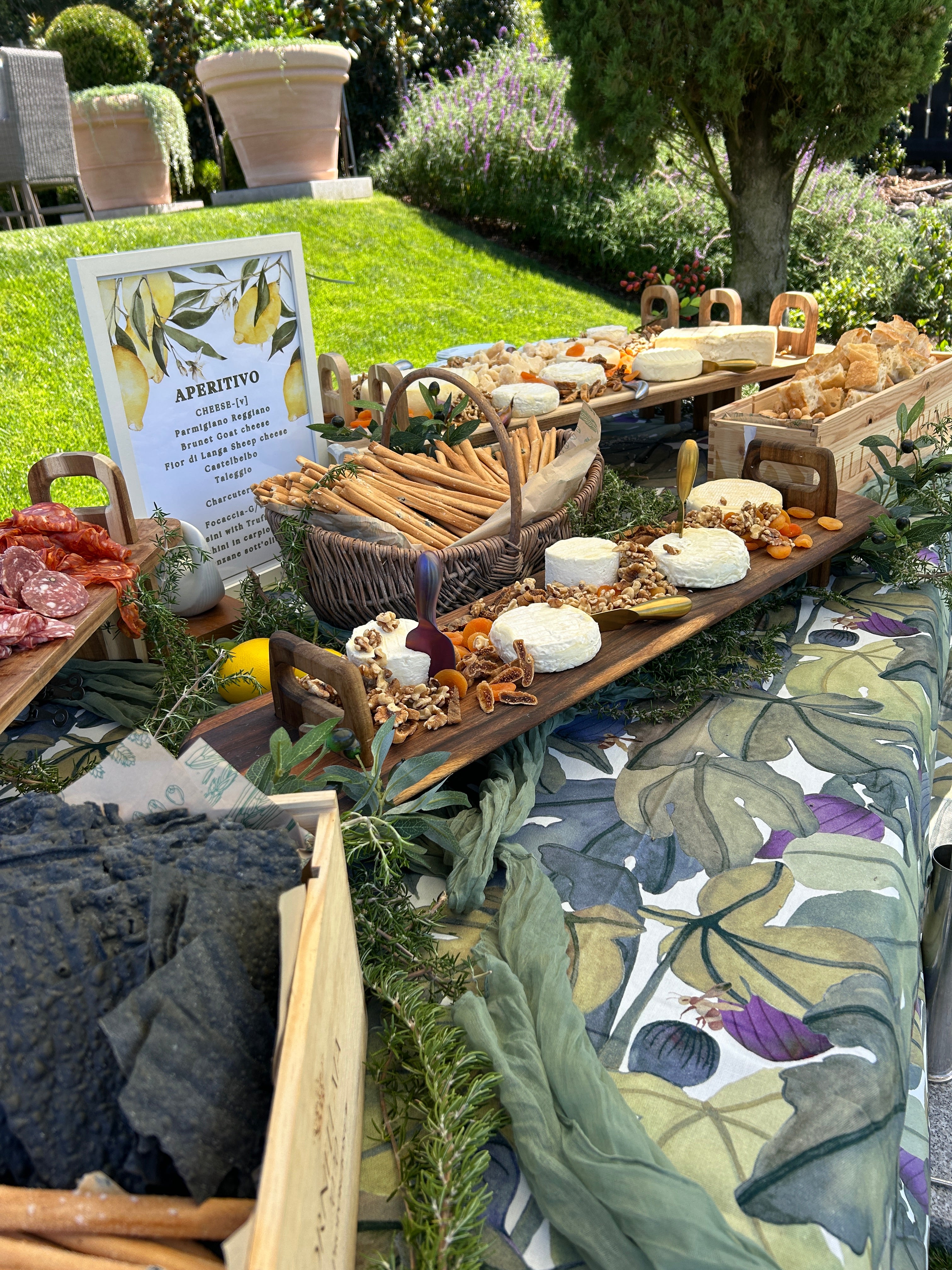 Decorative outdoor setup with a table, chairs, and floral arrangements.