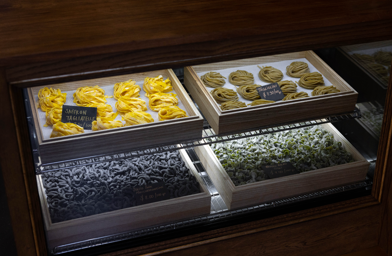Display case with various types of pasta in a store setting